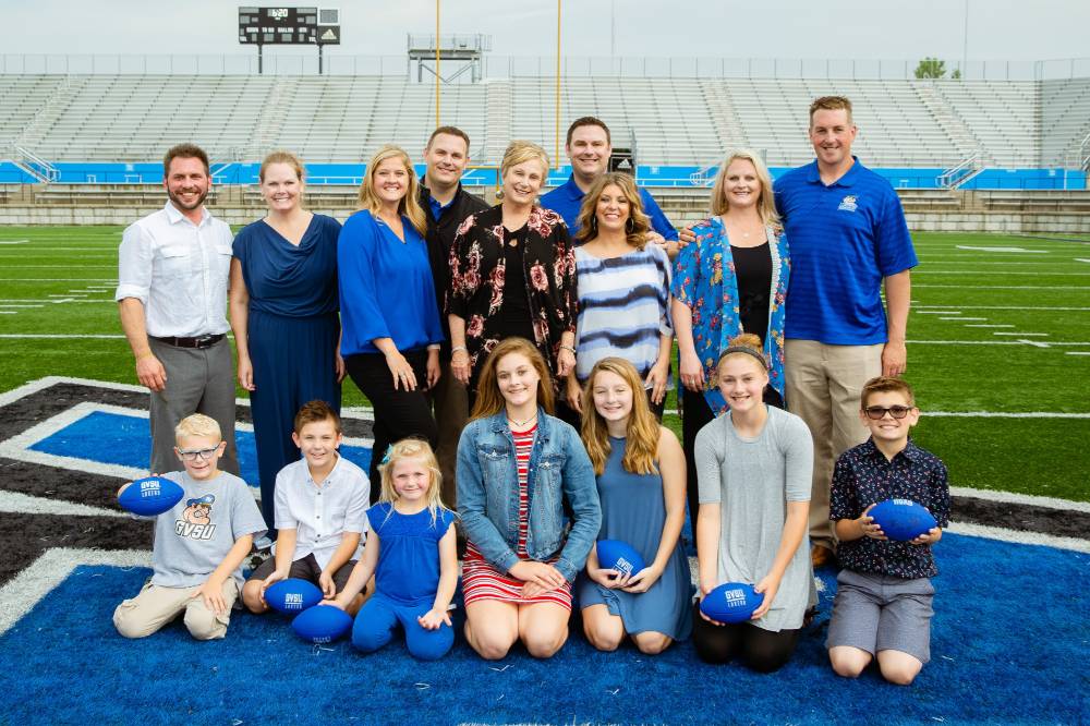 A group photo on the field at the Jamie Hosford Football Center dedication.